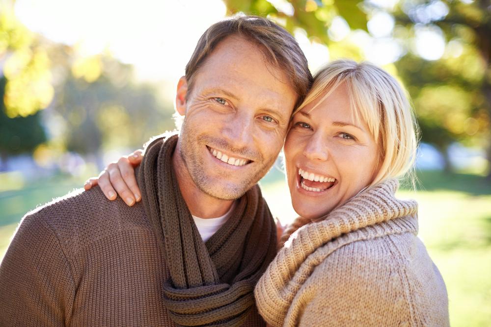 middle aged couple hugging and smiling | cosmetic dentist brentwood tn