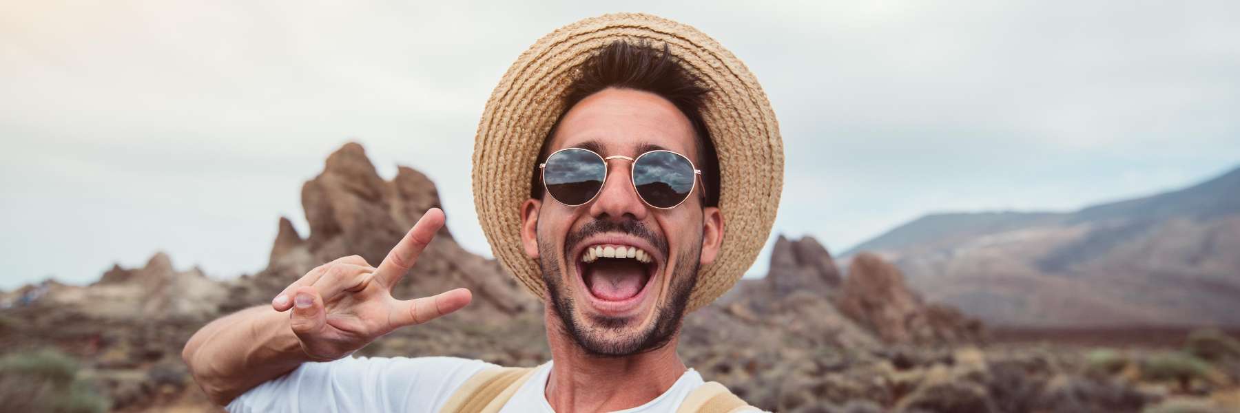 A smiling man in the mountains | Professional teeth whitening