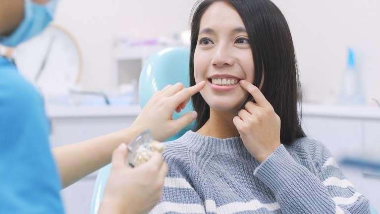 local cosmetic dentist | woman at dentist