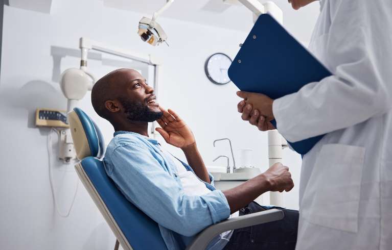 middle aged man talking to his brentwood dentist