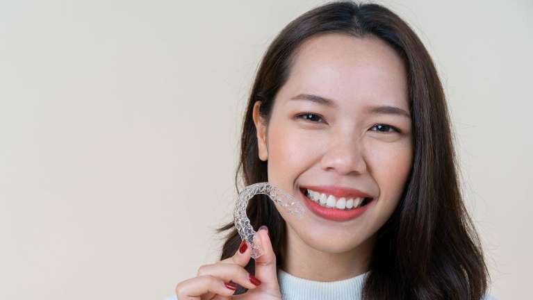 women holding invisalign in brentwood tn