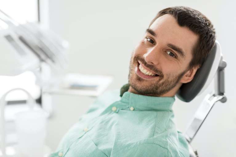 smiling man in the dental chair at the dentist in brentwood