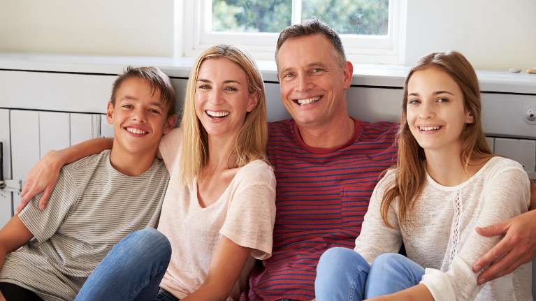 Happy family smiling together after dental checkups at Haley Schmitt, DDS in Brentwood TN