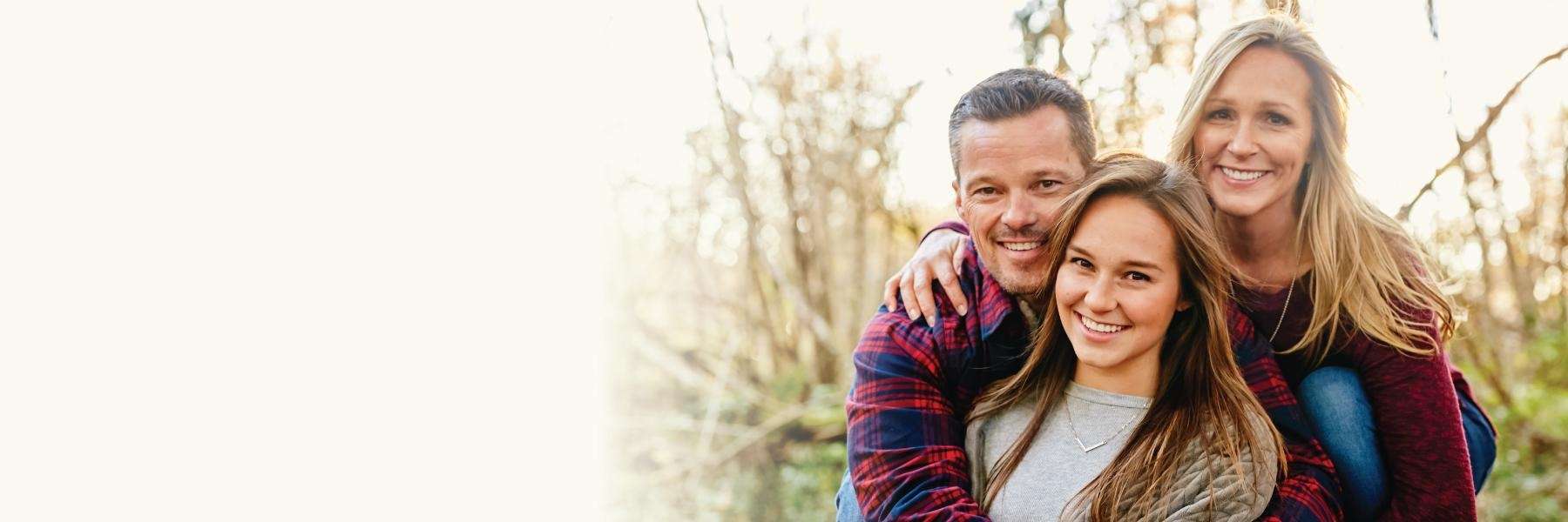 Smiling family outdoors after dental care at Haley Schmitt, DDS in Brentwood TN